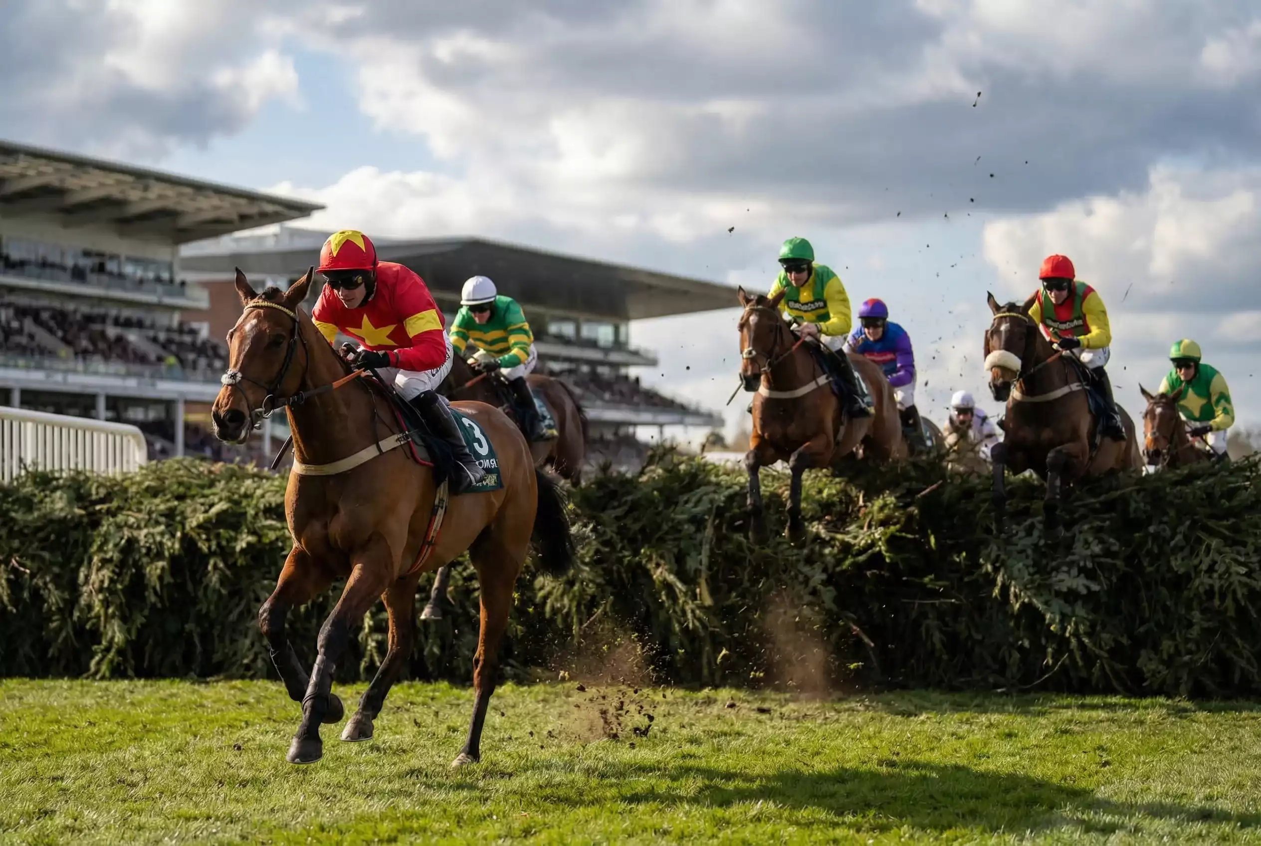 Horses and jockeys jumping famous Becher