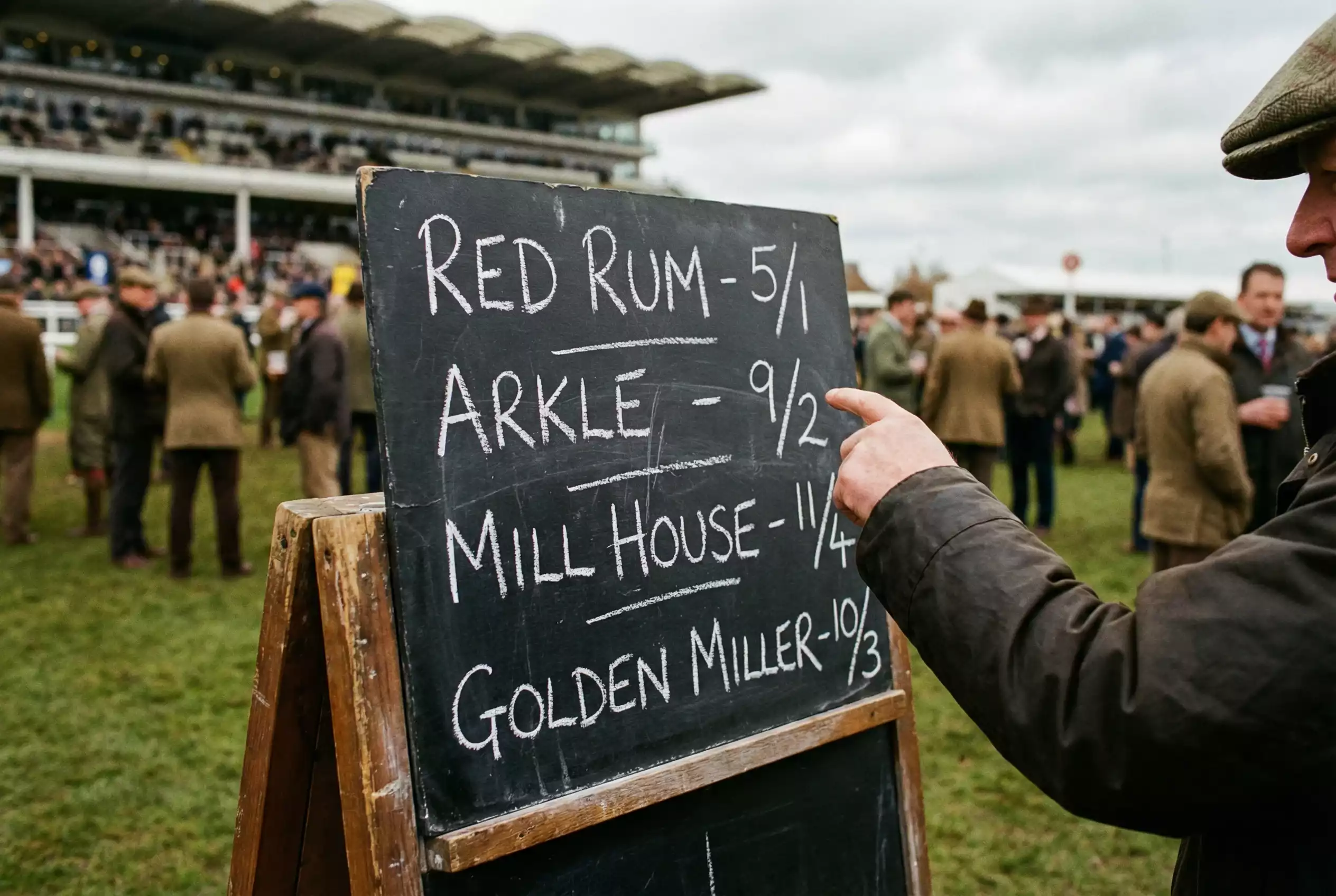 Bookmaker odds board at racecourse showing fractional betting prices